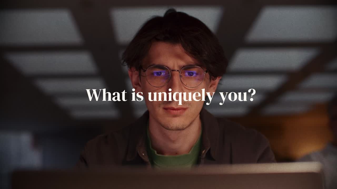 Video still: a person at a laptop with the text What is uniquely you?